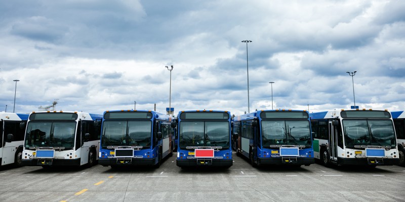 Public transit bus fleet parked at a depot, representing mobile assets on a hybrid cellular network